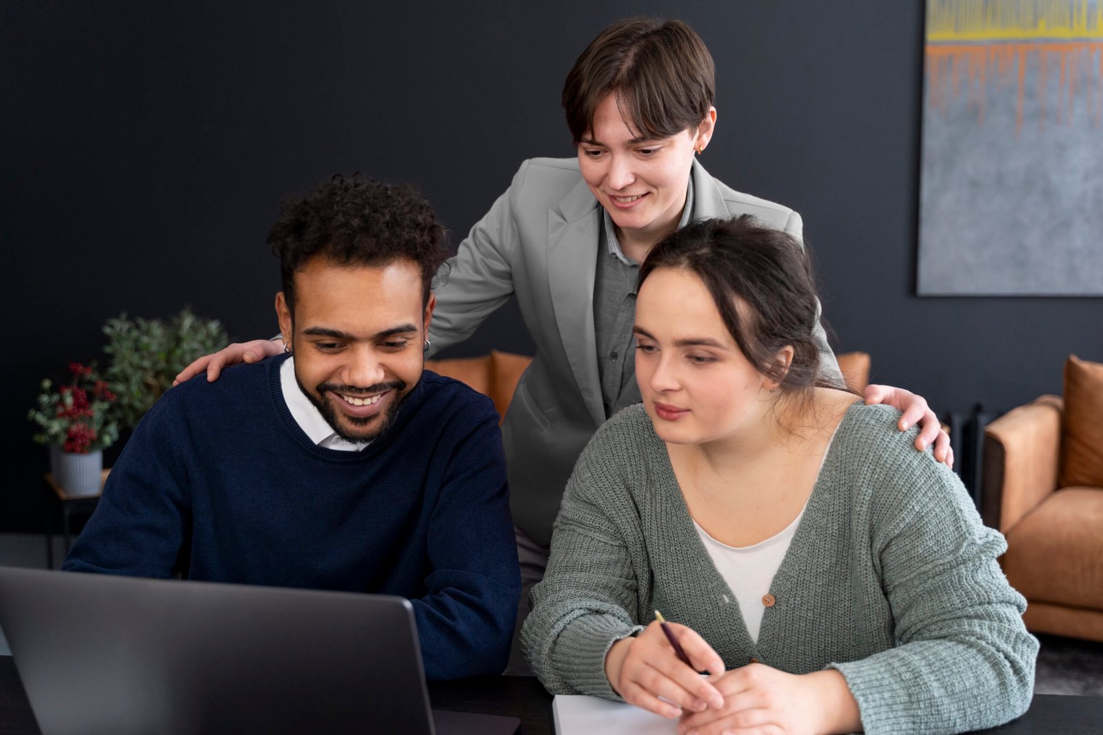 trans person working office with colleagues scaled